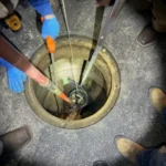 Rescuers were heartbroken to discover a tiny puppy trapped in a sewer drain.